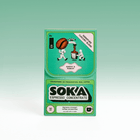 A package of SOKA Espresso Concentrate in the flavour 'SIGNATURE CHICORY BLEND', decorated with cartoon illustrations of characters playing squeezing a coffee bean into a cup, set against a light green gradient background.