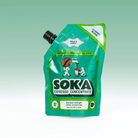 A green SOKA Espresso Concentrate pouch in the flavour 'CLASSIC BLEND', with a black spout cap, shown on a light green gradient background.