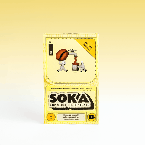 A box of SOKA Espresso Concentrate in the flavour 'FRENCH VANILLA', decorated with cartoon illustrations of characters playing squeezing a coffee bean into a cup, set against a yellow-to-white gradient background.